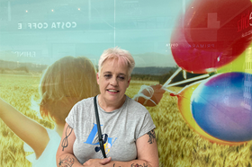 Amanda Gray standing in front of a colorful background