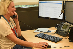 Staff member on the phone at computer