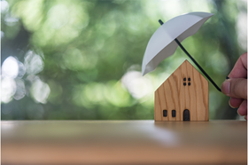 image of a toy house with an umbrella over it