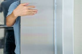 Male hand obstructing lift doors