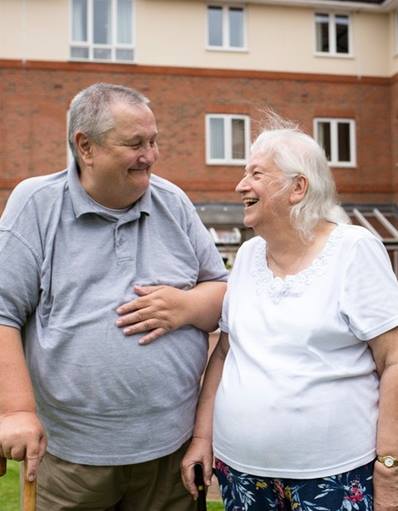 Elderly couple and residents at Chestnut Court together in communal area  customer photo shoot