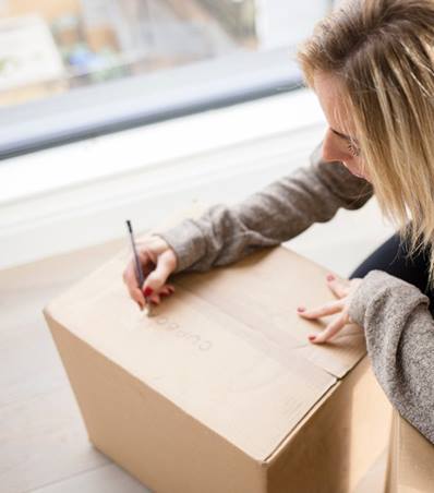 Woman moving into new home unpacking boxes