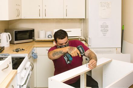 Kitchen fitter adding new units to a kitchen