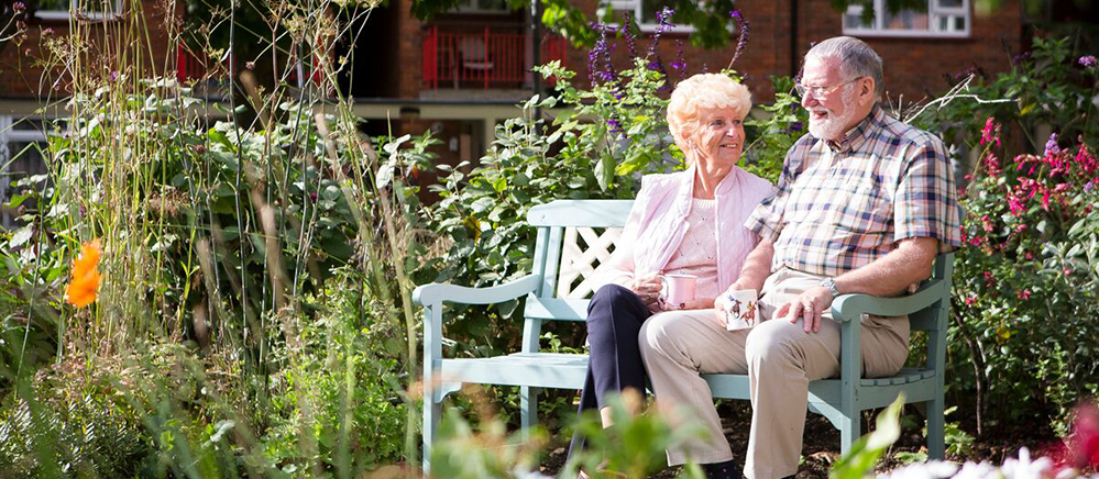 Retired couple sitting in the garden